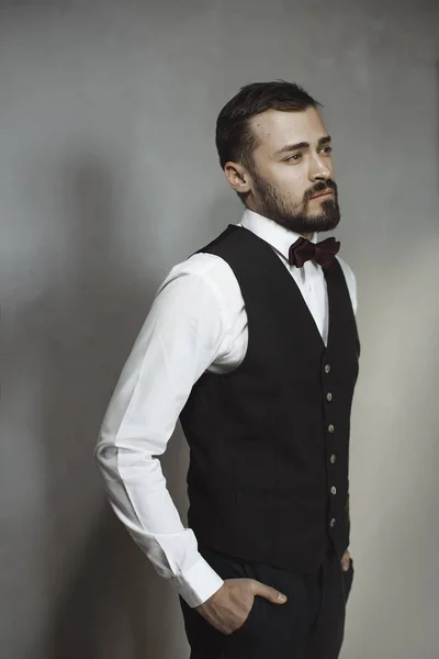 Smiling man in black vest and bow tie — Stock Photo, Image