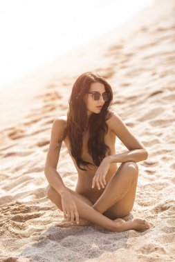Nude beautiful woman on the nudist beach. clipart