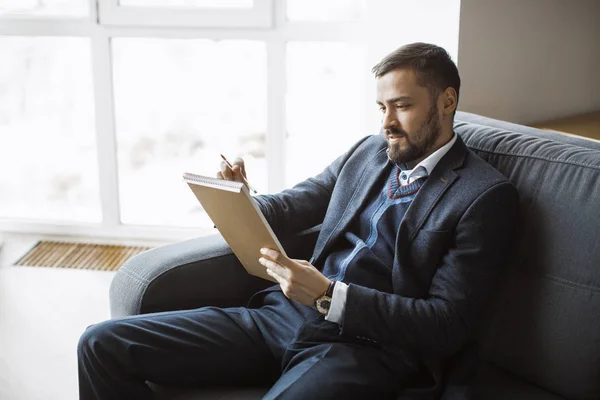 Hombre trabajando en la oficina haciendo notas — Foto de Stock