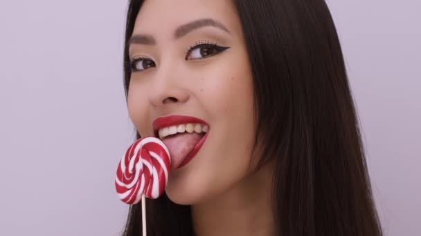 Fashion Portrait of Asian Woman with Lollipop in Studio — Stock Video