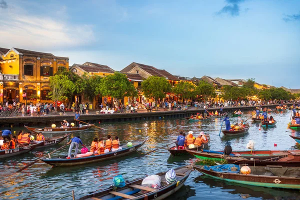Vietnam 'daki Hoi An nehri boyunca fener ışığında yüzen düzinelerce turist, etrafı parlayan binalar ve kalabalıklarla çevrili tekneler yakıyor. Canlı bir seyahat imajı turizm reklamları ve kültürel tanıtımlar için ideal.