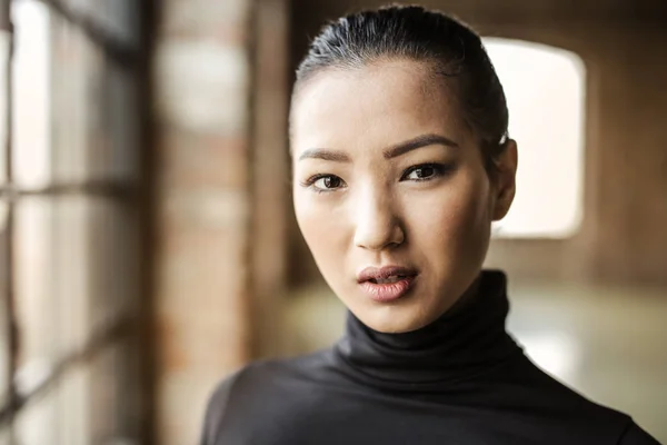 Beautiful young Asian woman portrait in a rustic building.