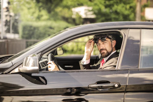 Curly Haired Businessman Driving His Car Looking Confidently — Stock Photo, Image