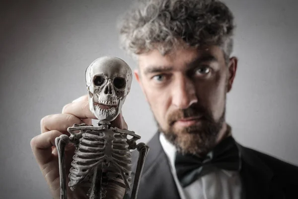 Homem Negócios Cabelos Encaracolados Com Laço Olhando Sério Mostrando Esqueleto — Fotografia de Stock
