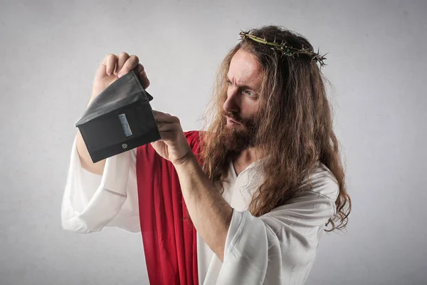 Man dressed up as Jesus searching for something in a wallet.