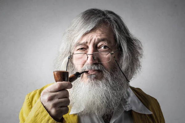 Old man with smoking pipe.