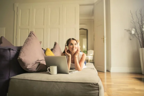 Jonge Vrouw Liggend Een Bed Luisteren Naar Muziek Haar Hoofdtelefoon — Stockfoto