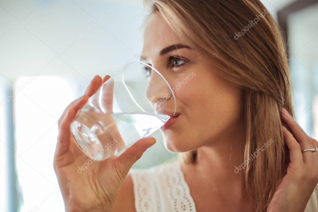 Young woman drinking water.