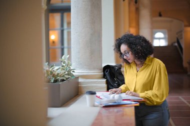 student reading notes in a beautiful building