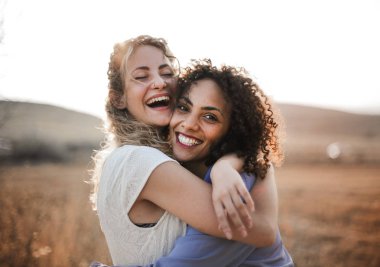happy friends embracing each other countryside clipart