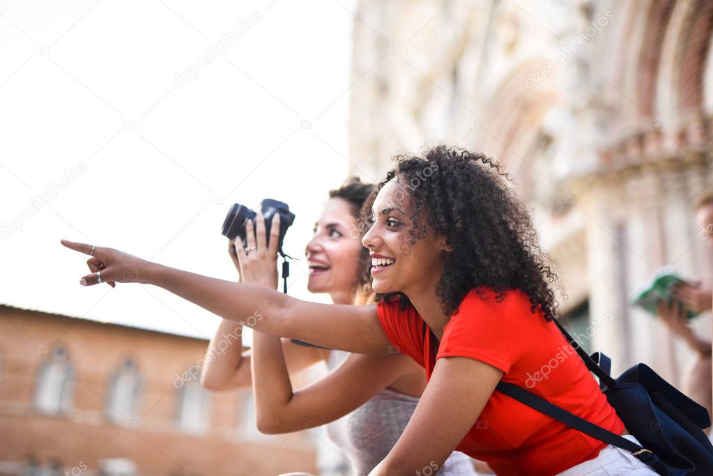 beautiful tourists pointing out somewhere