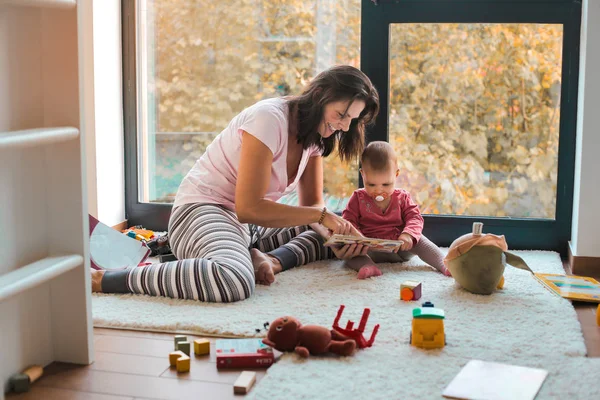 Mother and son playing and reading together at home