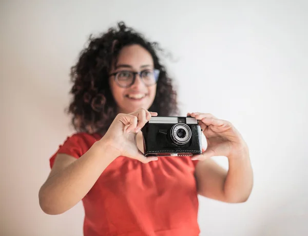 young woman in red shirt taking picture