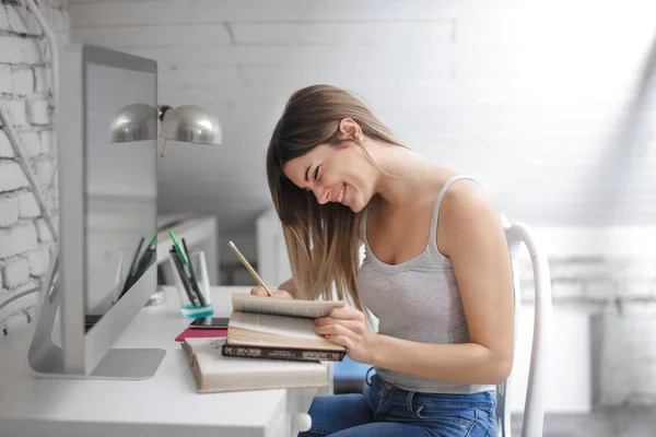 Lachende Jonge Vrouw Studeren Aan Het Bureau Tafel — Stockfoto