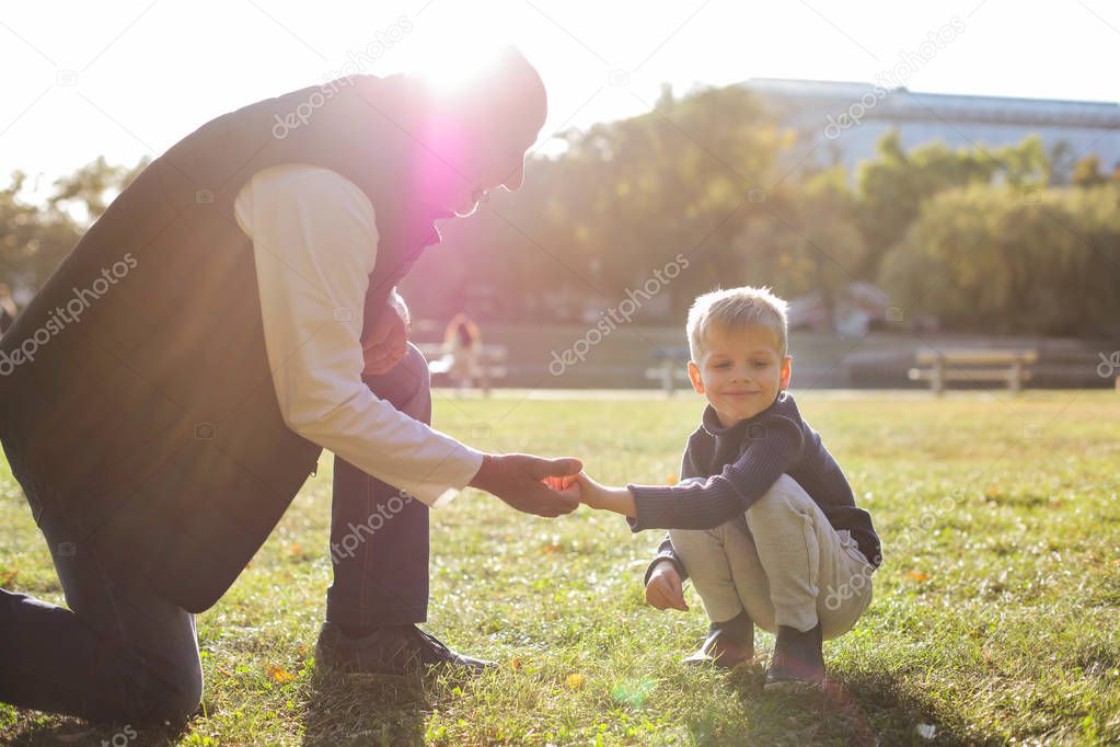 grandfather and grandson holding hands outdoor