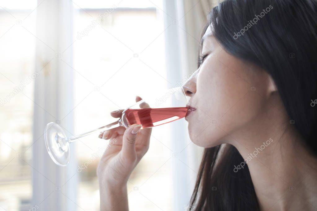 asian woman drinking wine
