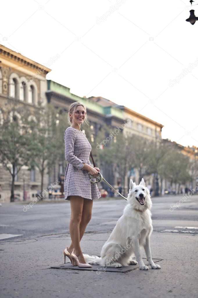 woman walking her dog in the street