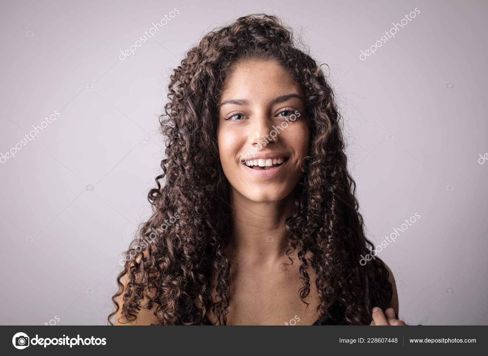 Young Curly Haired Brunette Woman Smiling Stock Photo by ©olly18 228607448