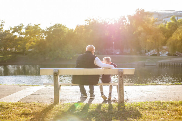 grandson and grandfather spending free time together in the park