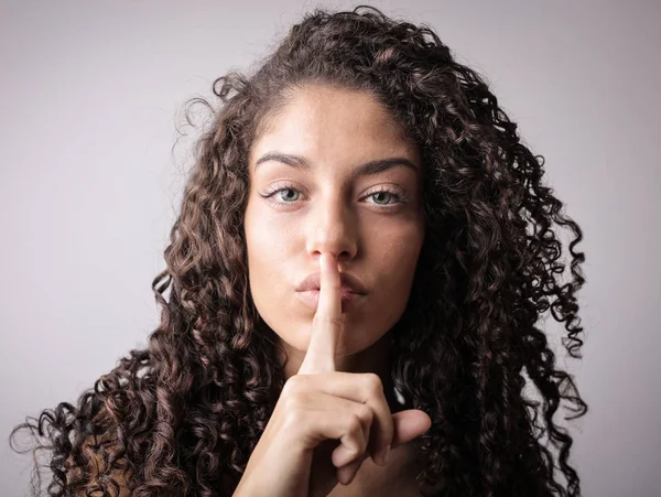 Young woman shows silence