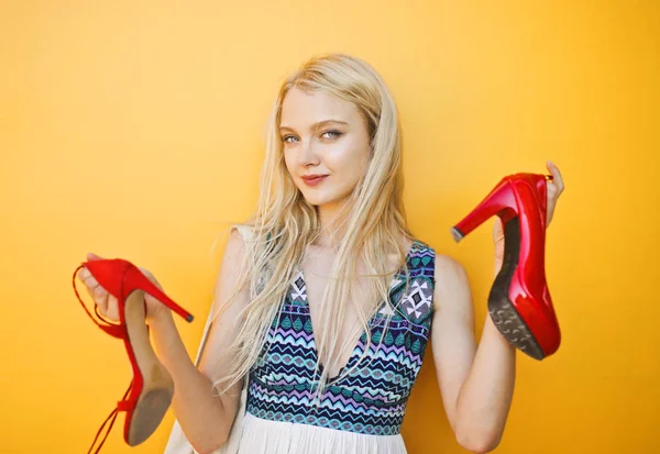 Blonde girl with two different shoes