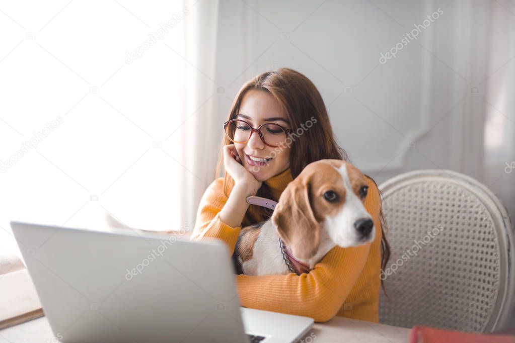 Red girl with a dog on the laptop