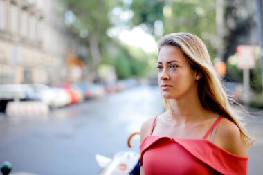Blonde girl is walking in the city