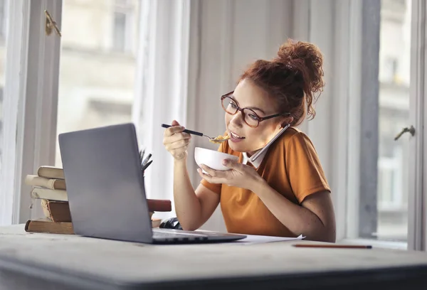 Mädchen Mittag Essen Während Sie Ihrem Laptop Arbeitet — Stockfoto