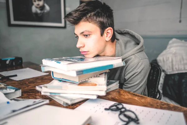 Bored teenager sleep over the books