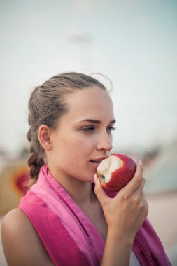 Girl is eating apple