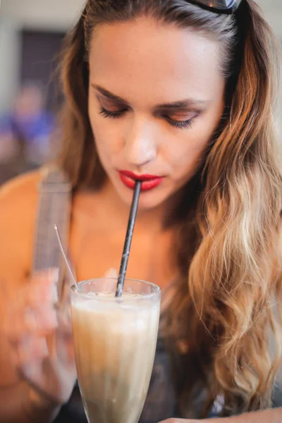 A girl drinking in a bar