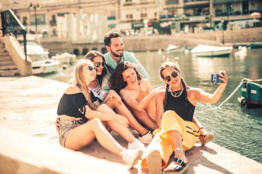 Bir grup arkadaş birlikte selfie çekiyorlar.