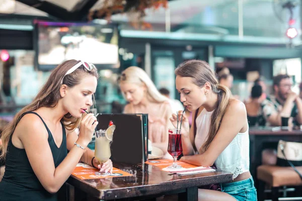 Girl are drinking in a bar