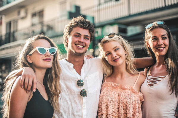 A group of friends hug together in the city