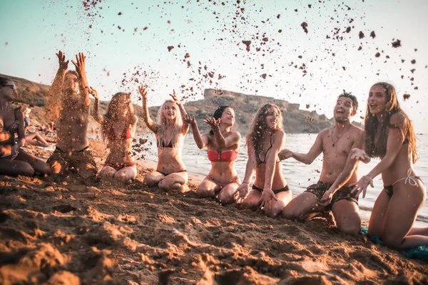 A group of friends have funny moment on the beach