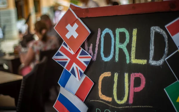 People Enjoying A World Cup Football Match At A Street Cafe In Europe