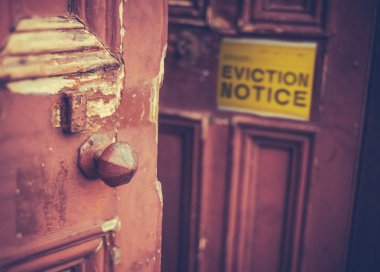 Grungy Old Door With A Yellow Eviction Notice clipart