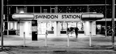 SWINDON, UK - DECEMBER 27, 2018: Swindon Railway Station in Wiltshire at night with light trails clipart