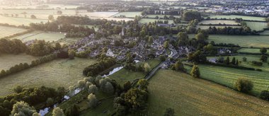 SWINDON UK - JULY 21, 2019: Aerial view of Lower Slaughter Cotswold village by River Windrush Gloucestershire clipart