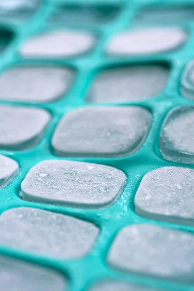 Ice cubes in green silicone mold — Stock Photo, Image
