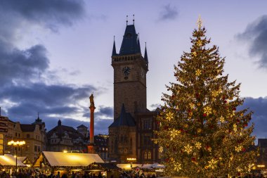 Illuminated Christmas tree decorated with lights at the festive market in Prague Old Town Square