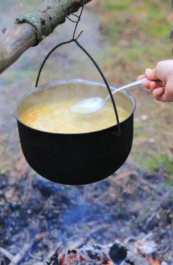 Ormanda kamp ateşi üzerinde füme turist kazana pişirme