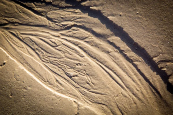 Natürlicher Hintergrund mit nassem Sand — Stockfoto