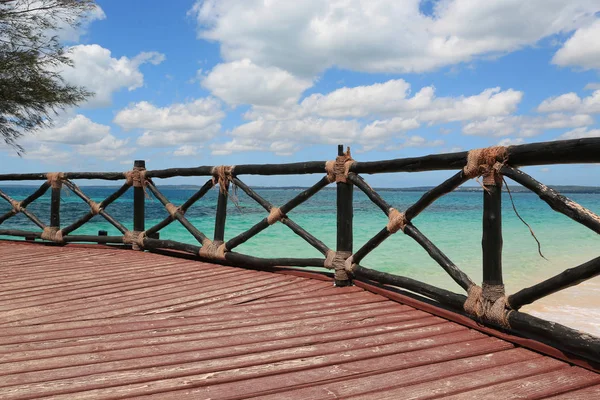 Fence of wooden bridge on sea shore — Stock Photo, Image
