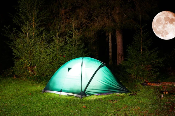 tourist tent in night forest