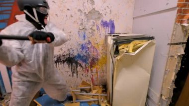 Olgun adam eski bir buzdolabı bir balyoz harabeye tarafından yok eder