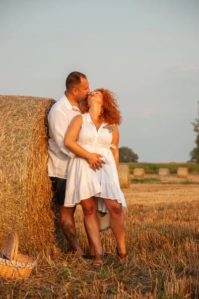 Романтическое свидание на свежесрезанном поле возле стога сена — стоковое фото