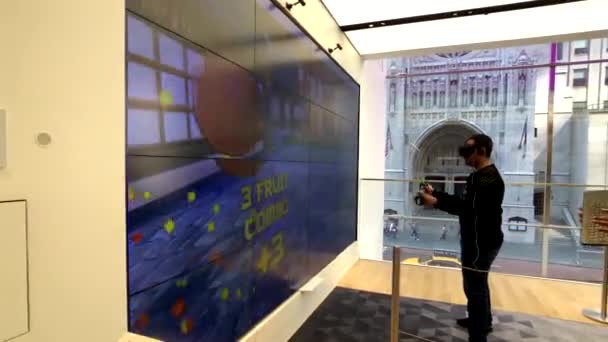 Player tests mixed reality game in helmet in Microsoft store — Stock Video