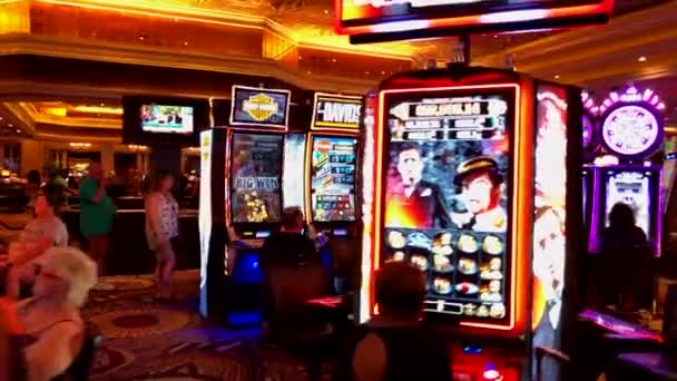 Люди играют в автоматы в казино MGM — стоковое видео