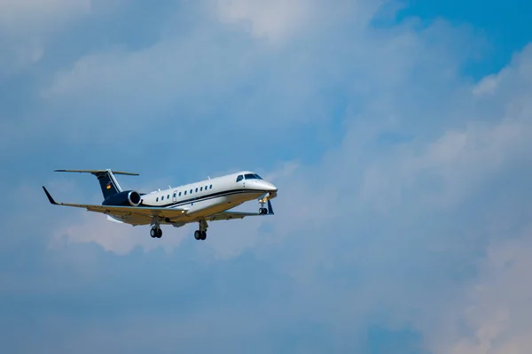 Small private jet airplane preparing for landing at day time in international airport — Stock Photo, Image